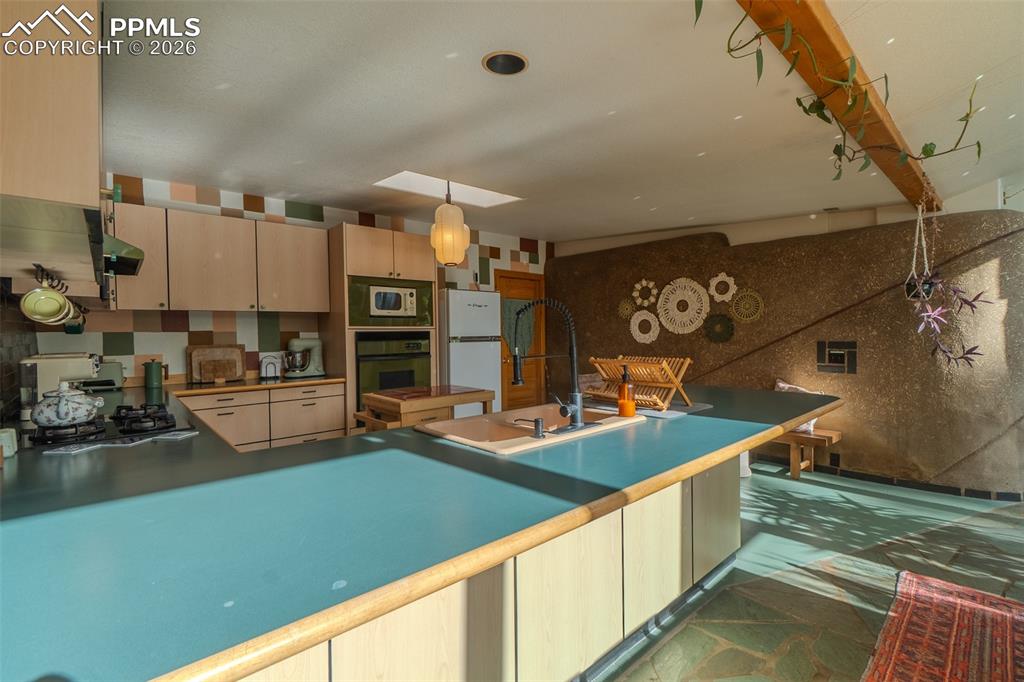 17160 Goshawk Road Colorado Springs, CO 80908 - Photo 15 of 43 a kitchen with lots of counter top space and stainless steel appliances