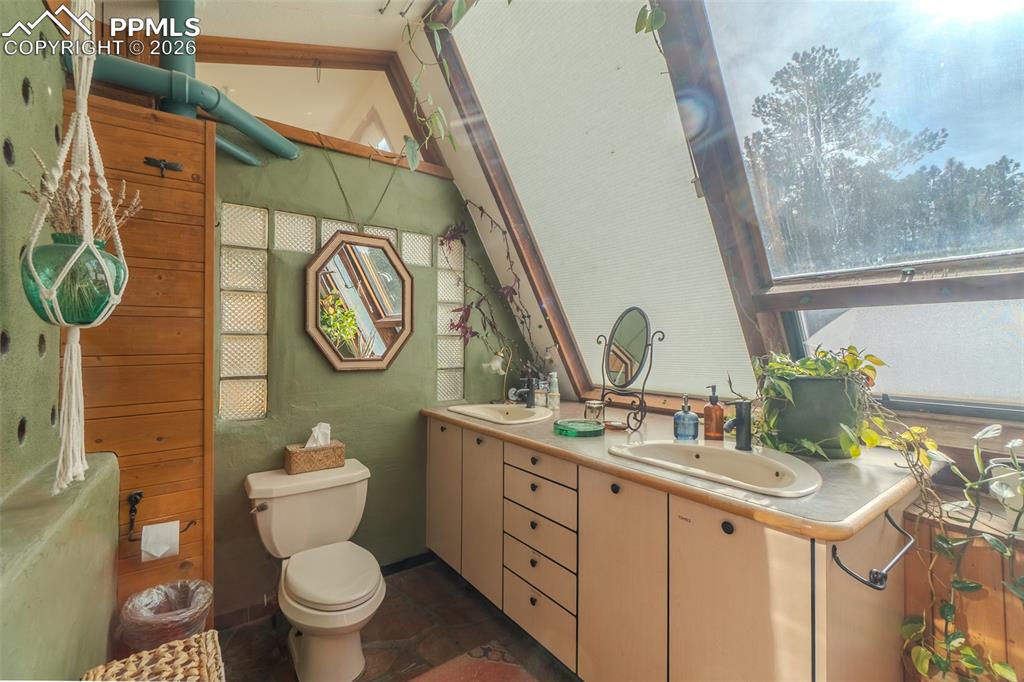 17160 Goshawk Road Colorado Springs, CO 80908 - Photo 17 of 43 a bathroom with a toilet sink and mirror