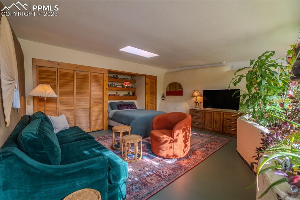 17160 Goshawk Road Colorado Springs, CO 80908 - Photo 24 of 43 a living room with furniture and a flat screen tv