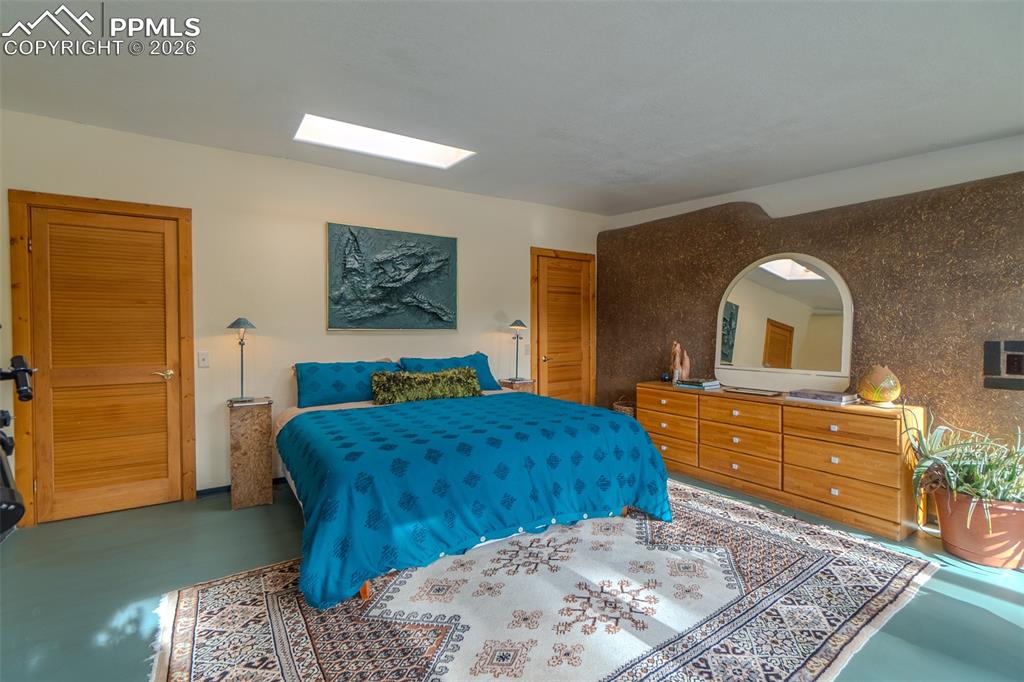 17160 Goshawk Road Colorado Springs, CO 80908 - Photo 26 of 43 a bedroom with a bed and a dresser