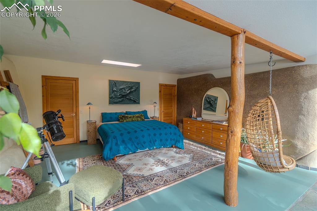 17160 Goshawk Road Colorado Springs, CO 80908 - Photo 27 of 43 a bedroom with a bed window and mirror