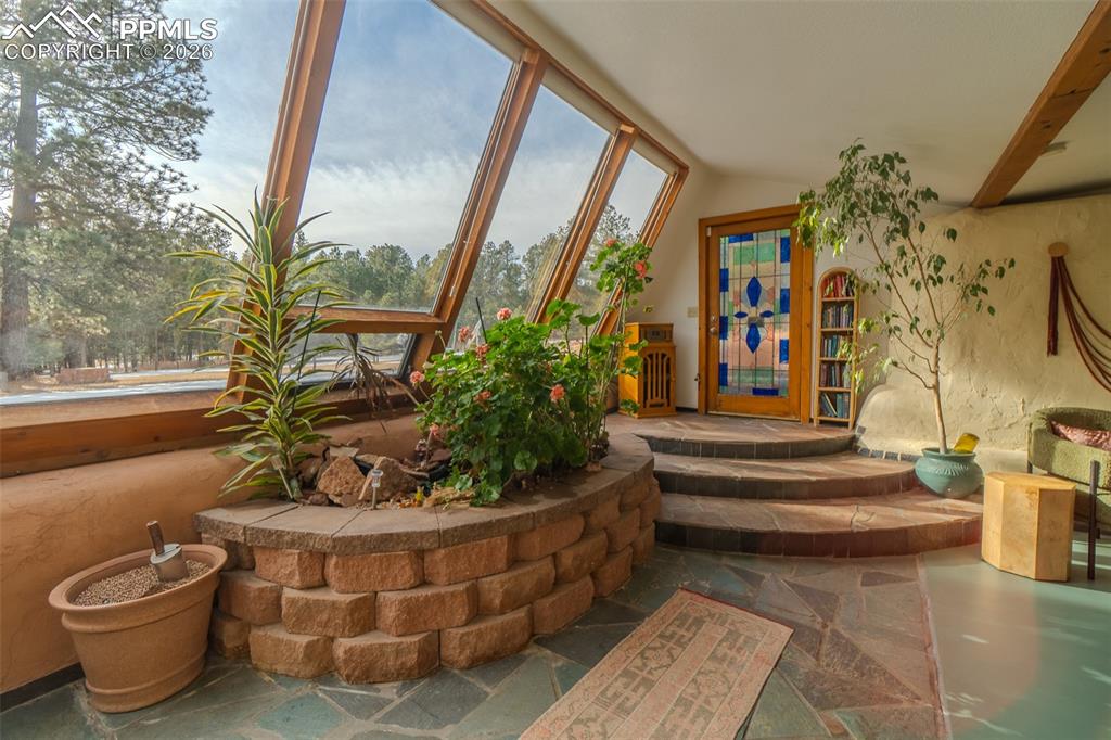 17160 Goshawk Road Colorado Springs, CO 80908 - Photo 31 of 43 a view of a porch with chairs and plants