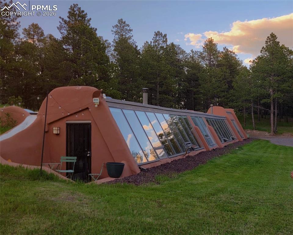 17160 Goshawk Road Colorado Springs, CO 80908 - Photo 36 of 43 a view of a backyard with a small cabin and wooden fence
