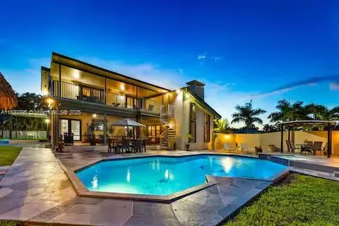 a view of a house with backyard tub and sitting area