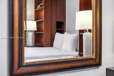 a bed sitting in a bedroom next to a lamp