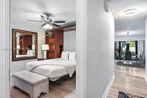 a bedroom with a bed and a painting on the wall