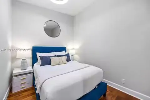 a large bed sitting in a bedroom next to a window