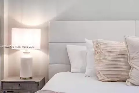 a patio with glass top table and chairs