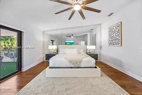 a view of a house with a big yard and large trees