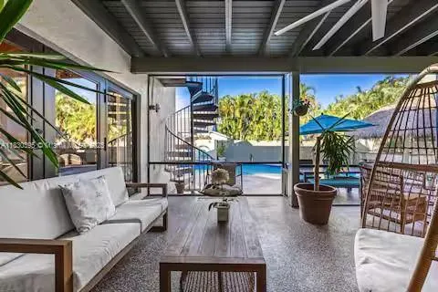 a view of a house with swimming pool having outdoor seating
