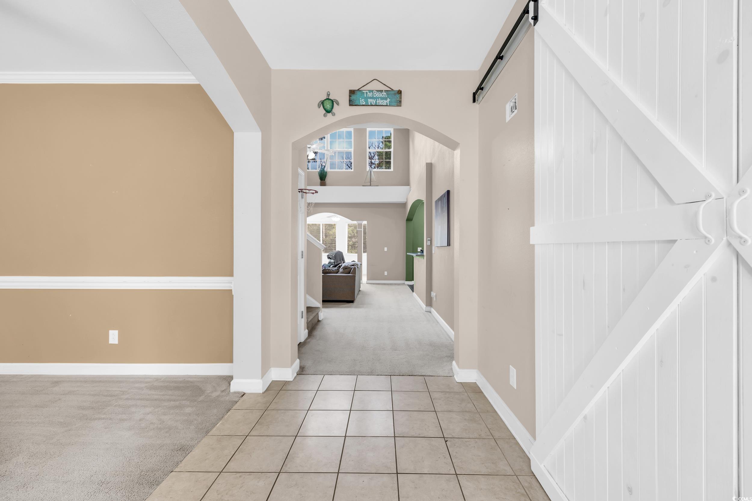 2352 Seneca Ridge Drive Myrtle Beach, SC 29579 - Photo 3 of 40 Carpeted entrance foyer with tile patterned floors, arched walkways, and a high ceiling