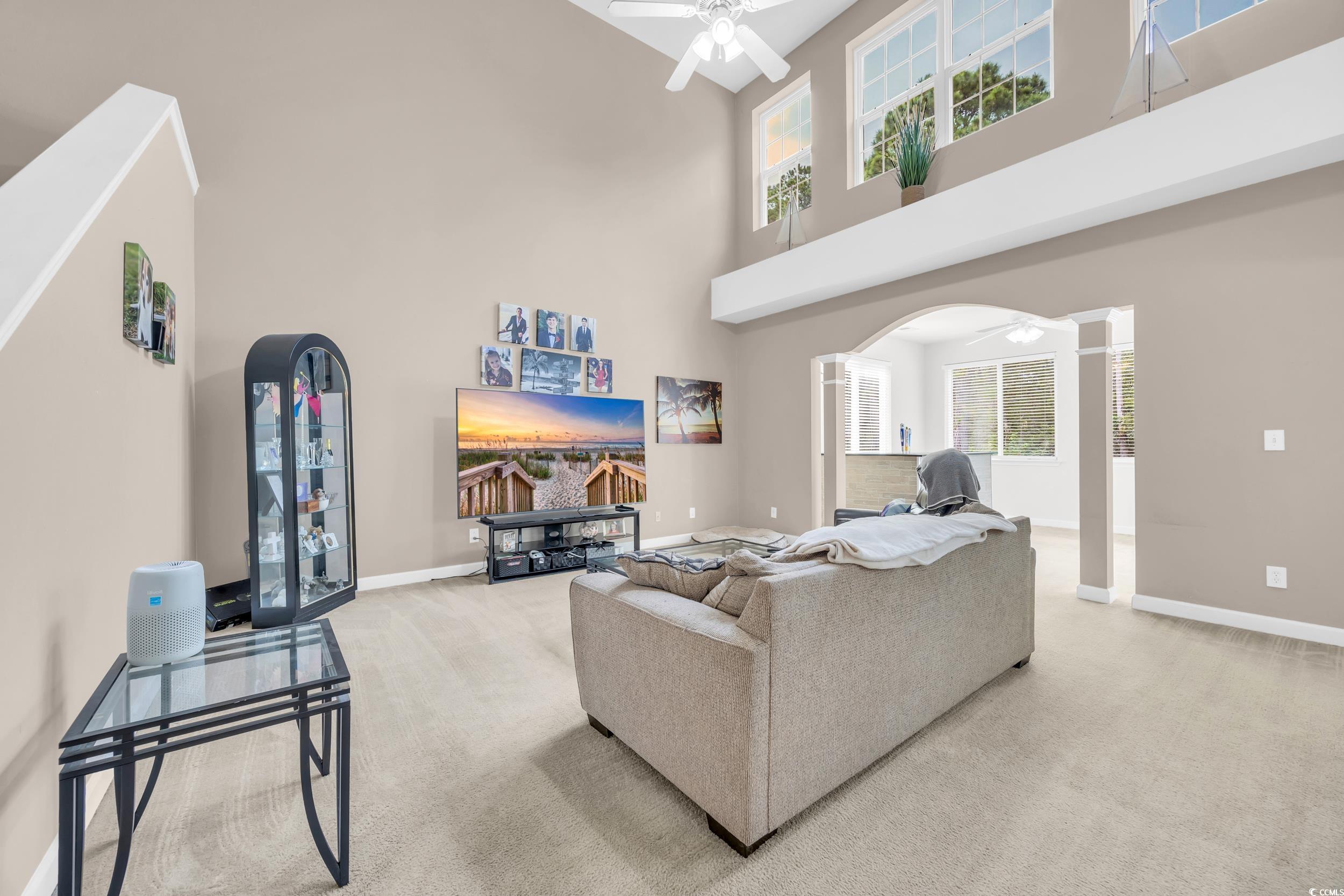 2352 Seneca Ridge Drive Myrtle Beach, SC 29579 - Photo 6 of 40 Carpeted living area with ceiling fan and a towering ceiling