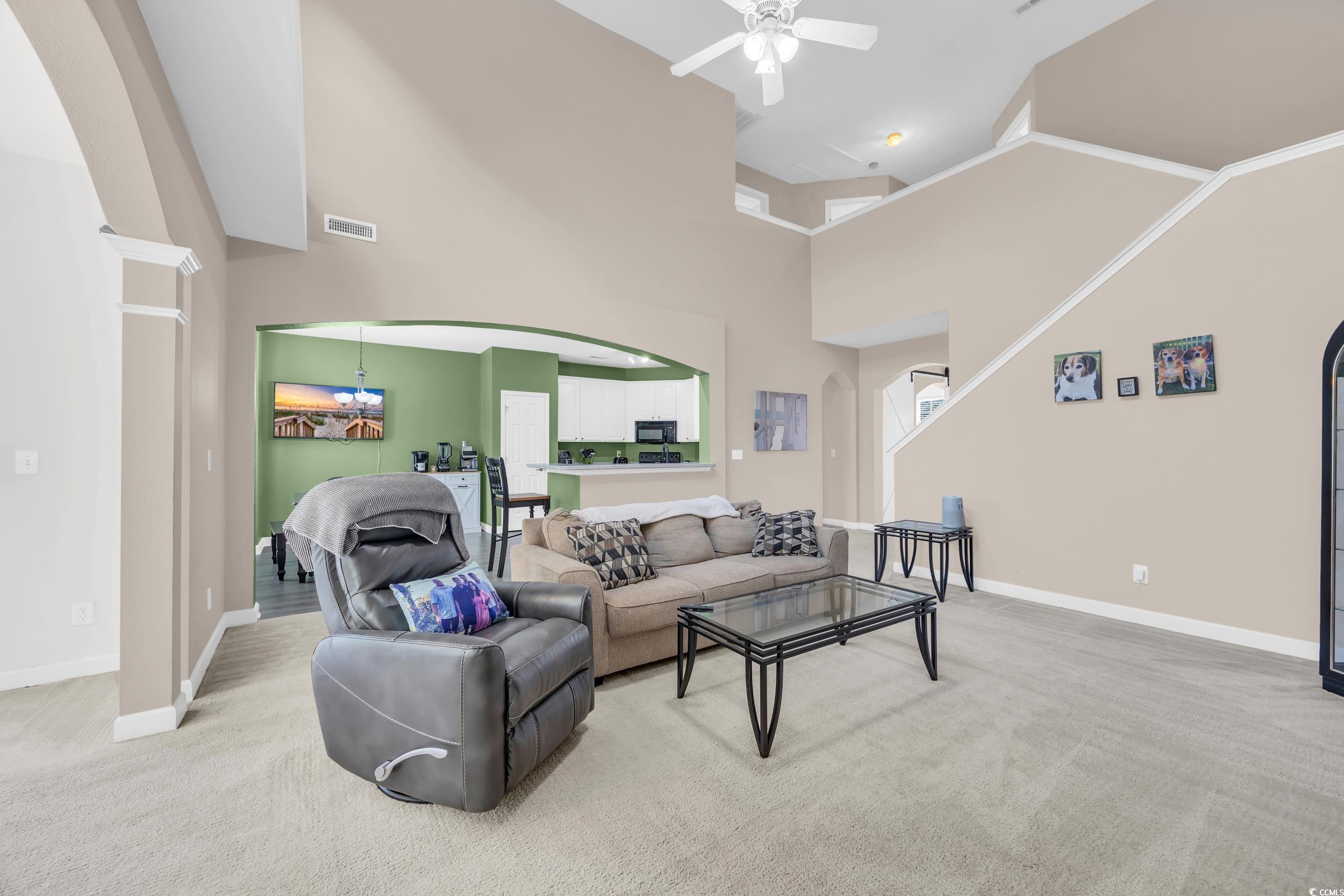 2352 Seneca Ridge Drive Myrtle Beach, SC 29579 - Photo 8 of 40 Living room with arched walkways, light colored carpet, high vaulted ceiling, and a ceiling fan