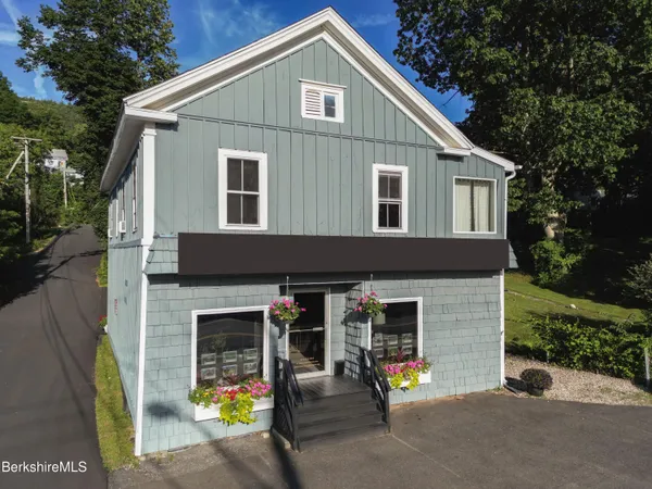 a view of a house with outdoor seating area