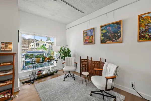 a work room with furniture and a potted plant