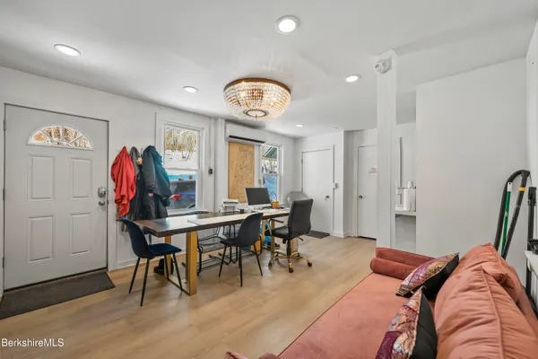 a view of a dining room with furniture and wooden floor