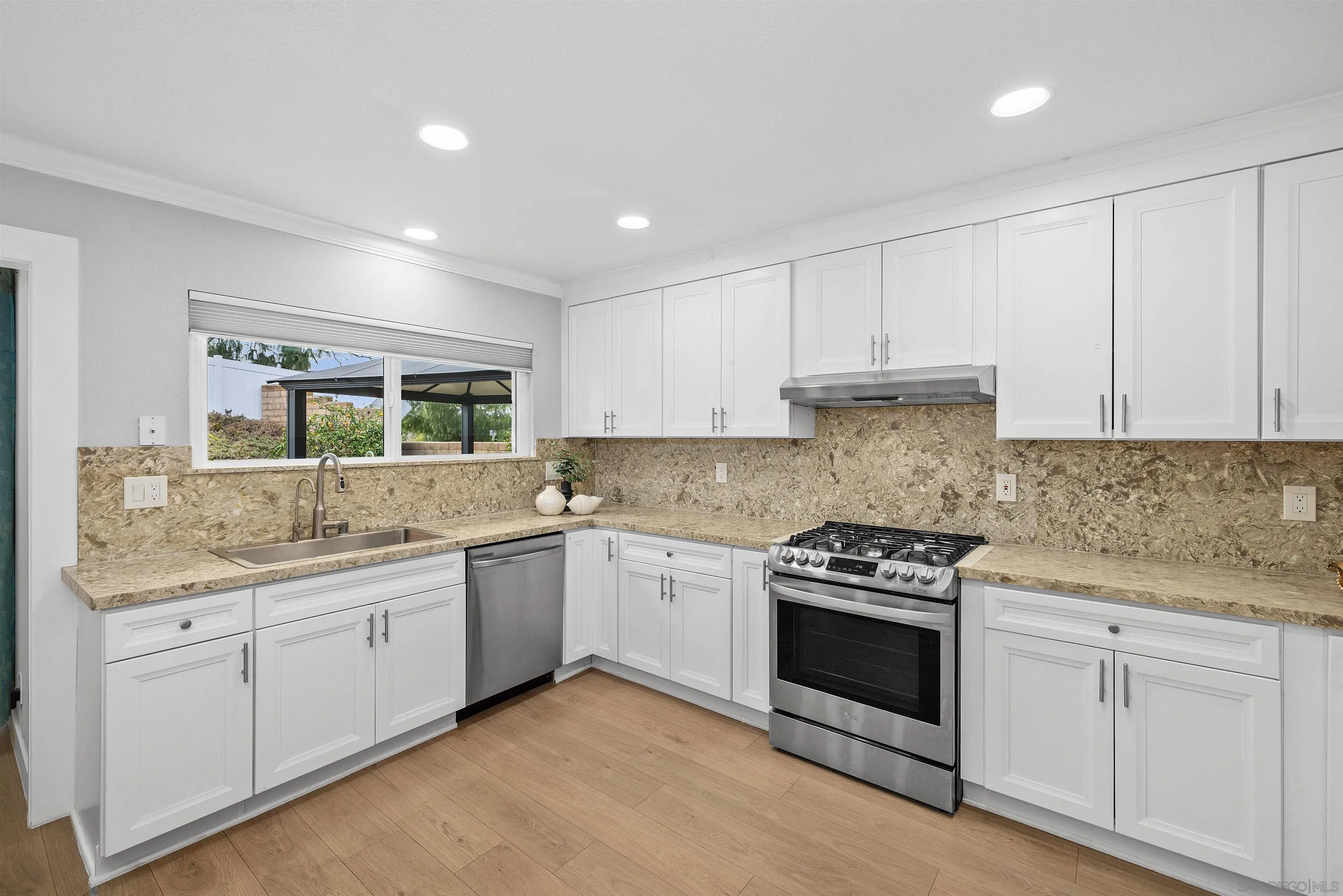 12866 Summerfield Lane Poway, CA 92064 - Photo 23 of 33 a kitchen with granite countertop white cabinets and white appliances