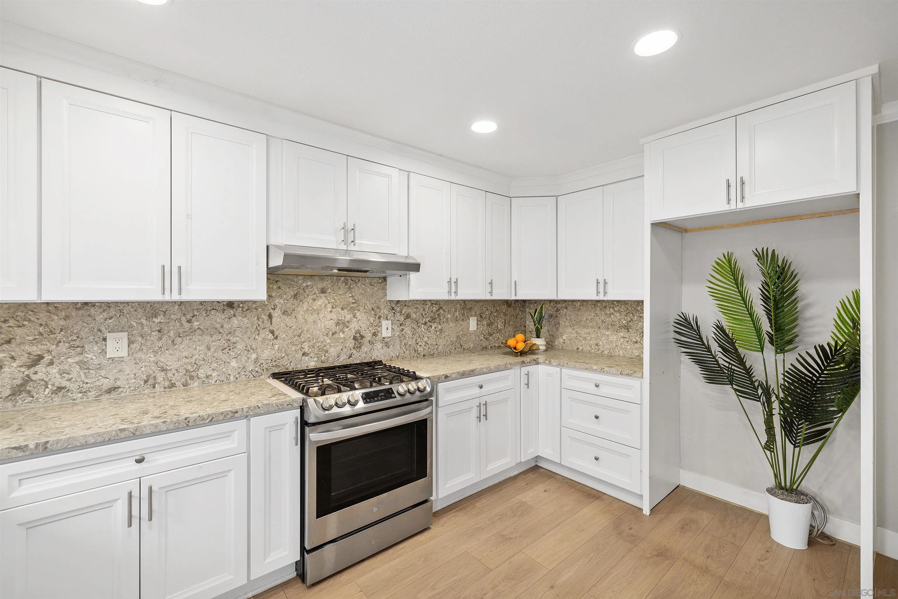 12866 Summerfield Lane Poway, CA 92064 - Photo 24 of 33 a kitchen with stainless steel appliances white cabinets and a stove top oven