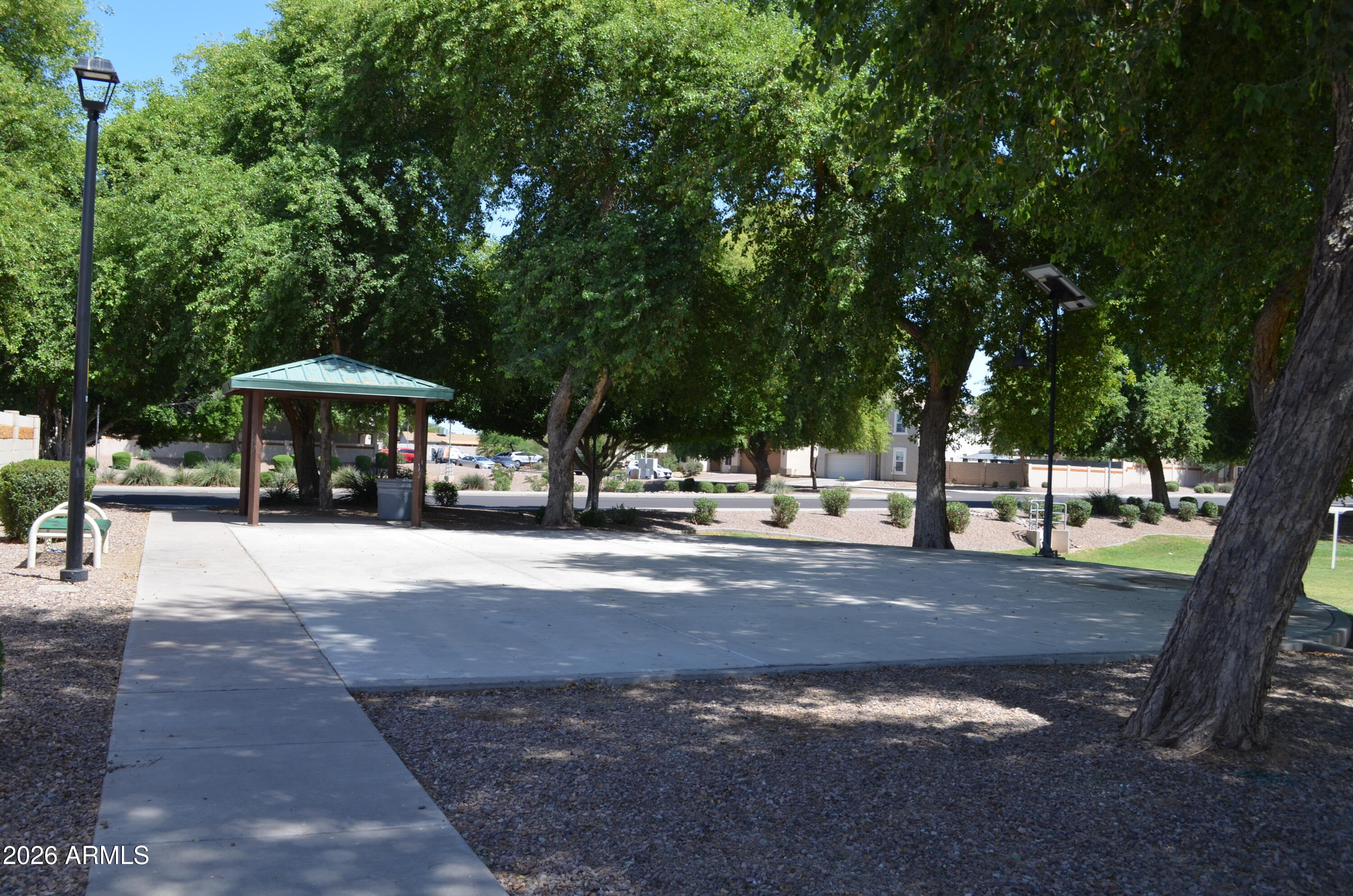5409 South 11th Street Phoenix, AZ 85040 - Photo 16 of 17 a view of a street with trees and sign board