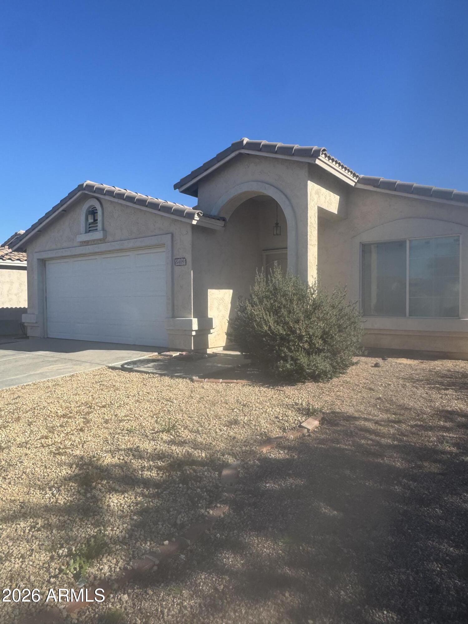 5409 South 11th Street Phoenix, AZ 85040 - Photo 2 of 17 a front view of a house with a yard