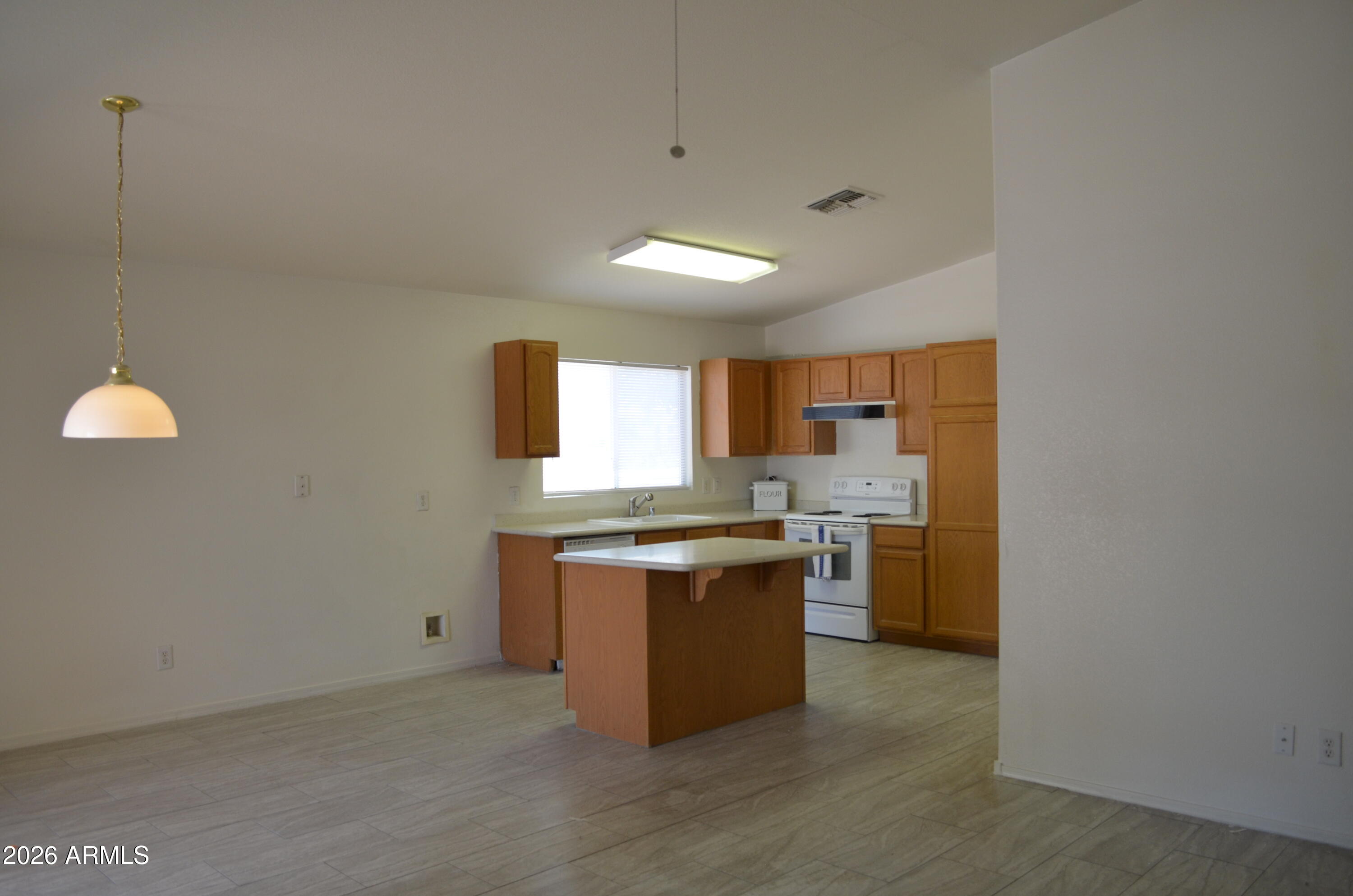 5409 South 11th Street Phoenix, AZ 85040 - Photo 6 of 17 a kitchen with a stove a sink and a refrigerator