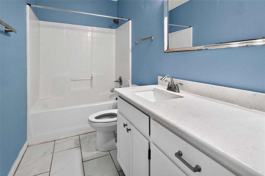 124 Topaz Circle Hewitt, TX 76643 - Photo 19 of 35 Bathroom featuring a white vanity with an integrated sink, a light-colored countertop, and a brushed nickel faucet