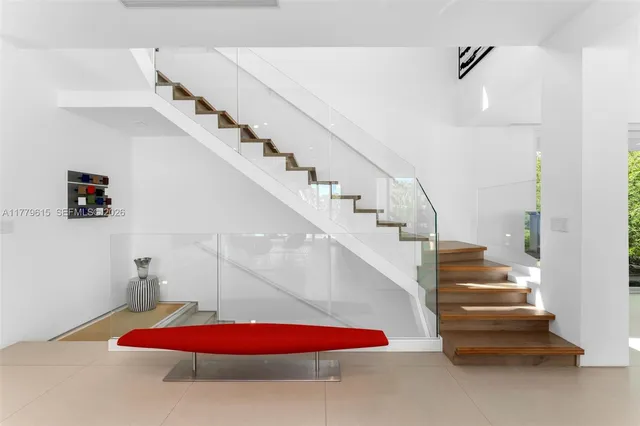 a living room with furniture and a stairs