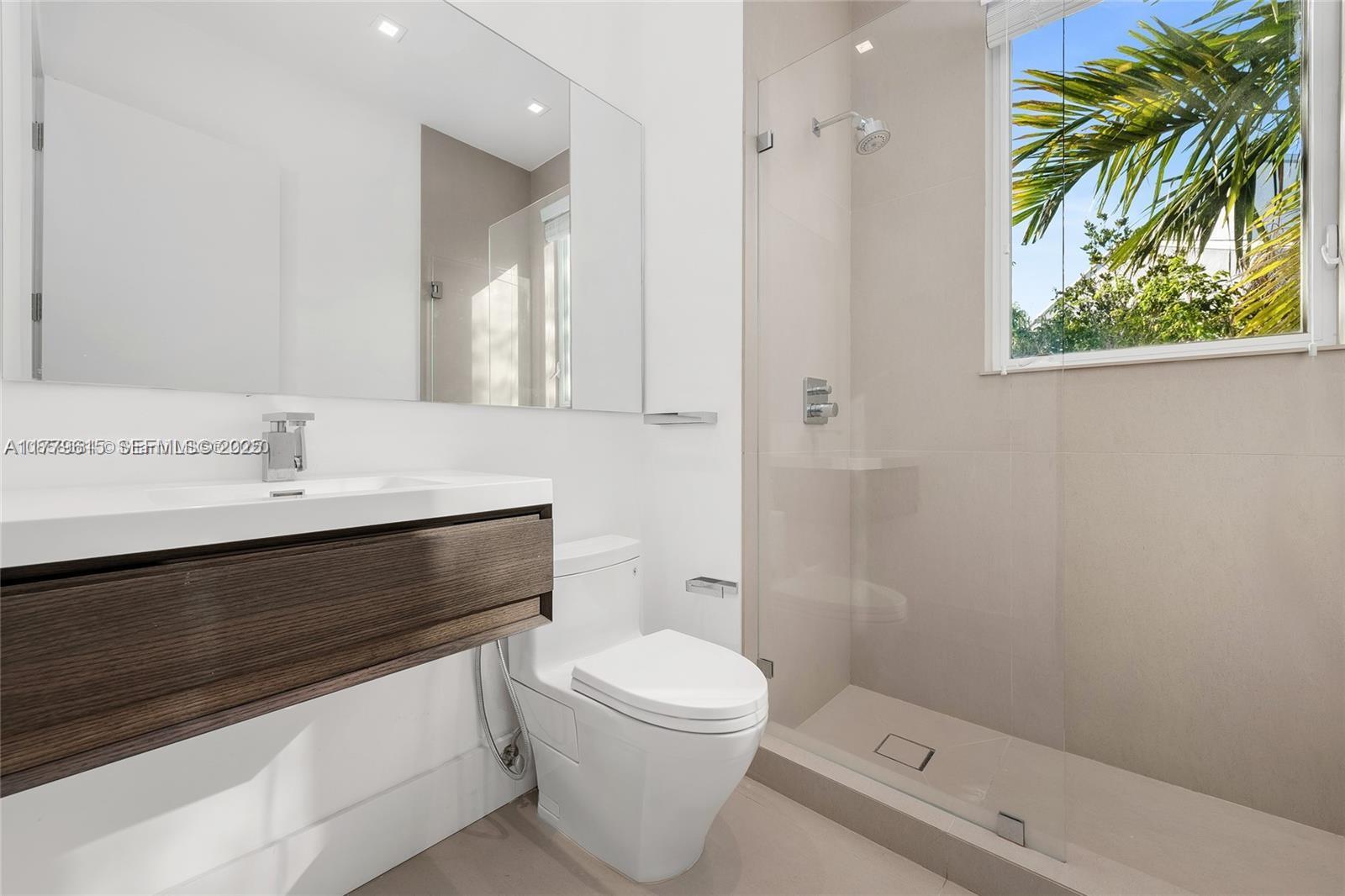 481 South Mashta Drive Key Biscayne, FL 33149 - Photo 24 of 57 a bathroom with a sink a toilet and shower