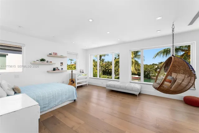 a bedroom with furniture and a window