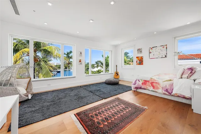 a room with lots of trees and windows