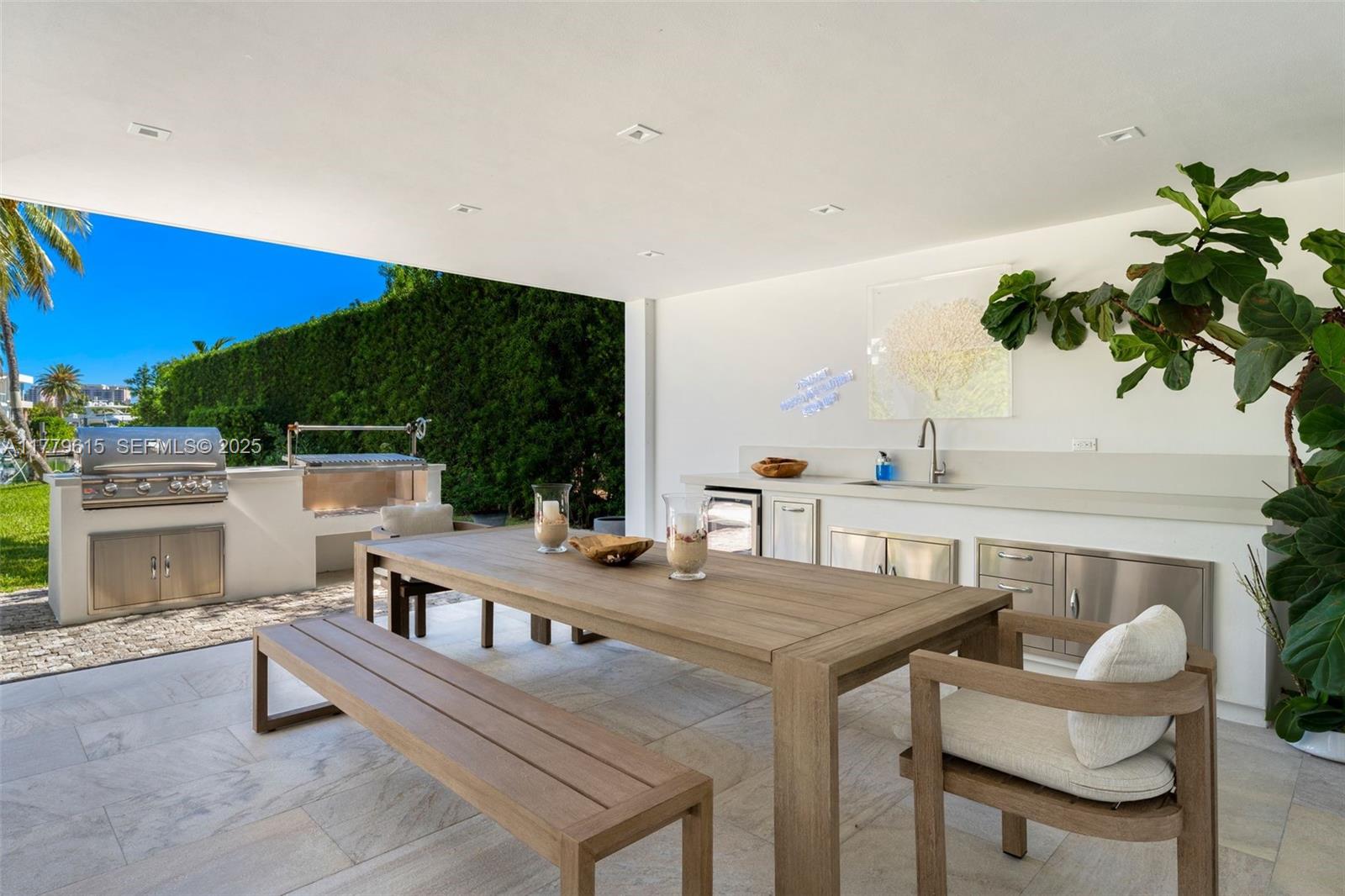 481 South Mashta Drive Key Biscayne, FL 33149 - Photo 45 of 57 a view of a dining table and chairs in the patio