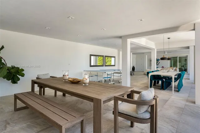 a view of a swimming pool with a table and chairs