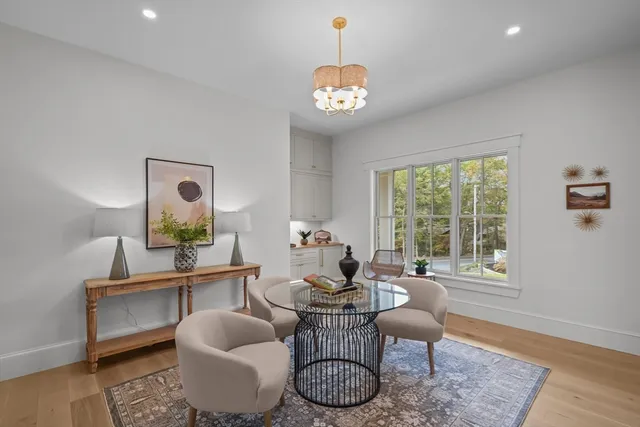 a bedroom with a bed and dresser with mirror