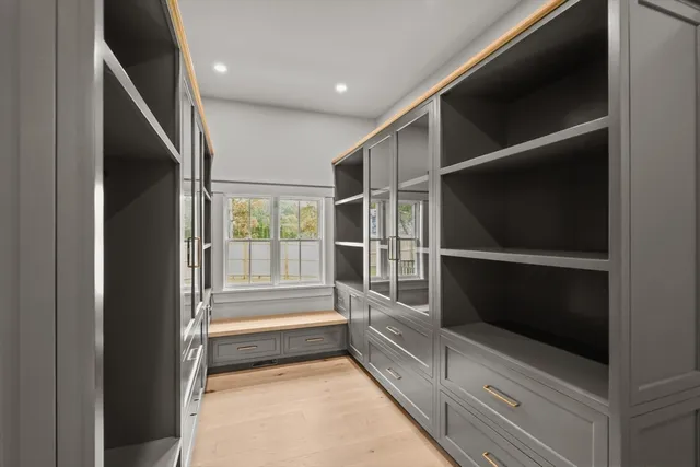 a bathroom with double vanity and a mirror