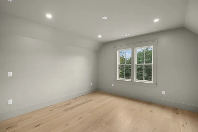 a kitchen with a sink cabinets and wooden floor