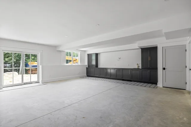 a view of a room with an empty space and empty shelves