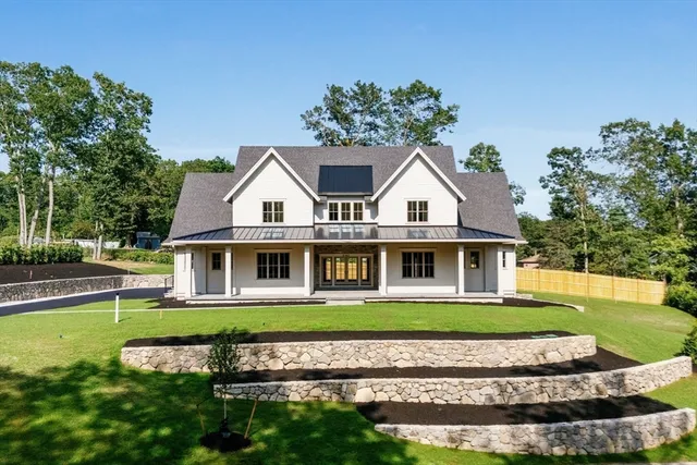 an aerial view of a house with swimming pool garden and outdoor seating