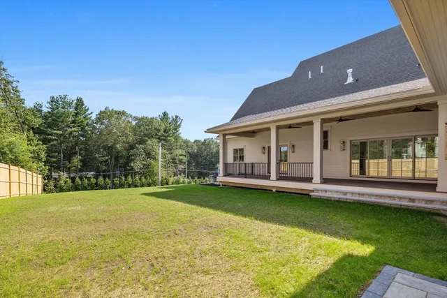 a view of a house with swimming pool and a yard