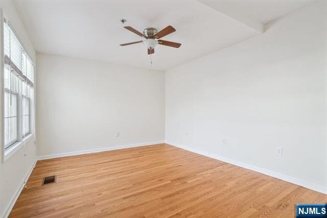 683 Main Street, Unit 2 Hackensack, NJ 07601 - Photo 7 of 15 wooden floor in an empty room with a window