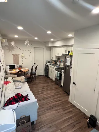 a living room with lots of furniture and kitchen view