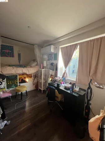 a room with lots of wooden furniture and a large window