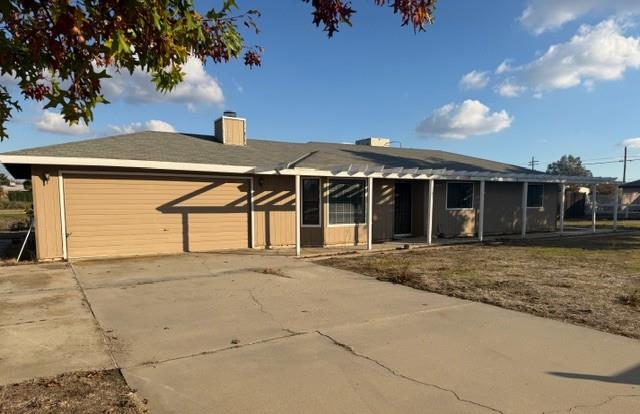 17067 Avon Way Madera, CA 93638 - Photo 14 of 14 a front view of a house with a yard and garage
