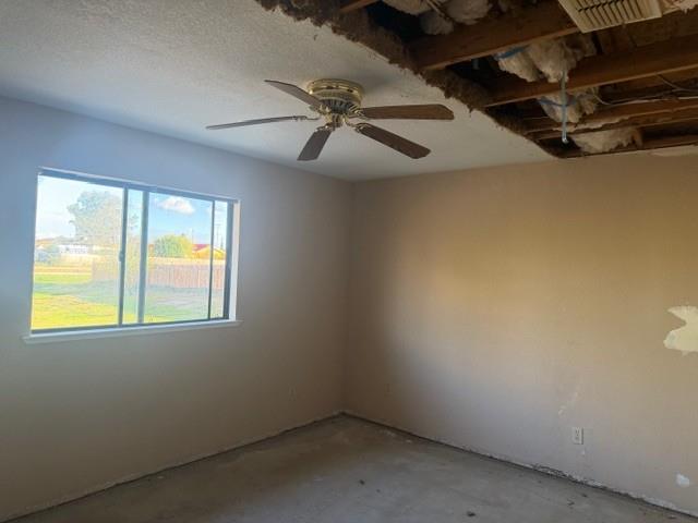 17067 Avon Way Madera, CA 93638 - Photo 8 of 14 an empty room with windows and fan