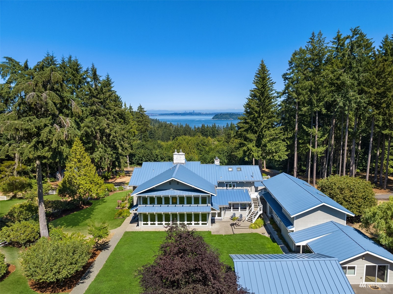 7382 View Park Road Southeast Port Orchard, WA 98367 - Photo 3 of 40 a view of a big house with a big yard plants and large trees