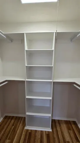 a view of walk in closet with empty racks