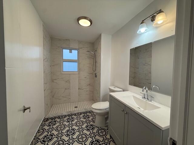 919 2nd Street, Unit 2 West Palm Beach, FL 33401 - Photo 11 of 14 a bathroom with a sink a toilet a shower and a mirror