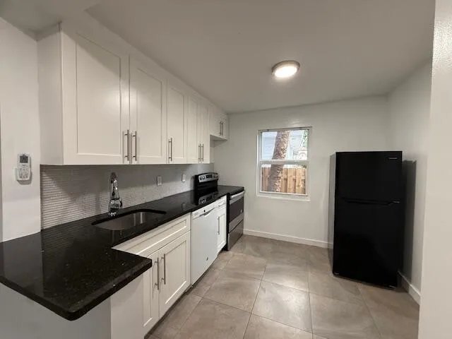 a kitchen that has a sink and a stove in it