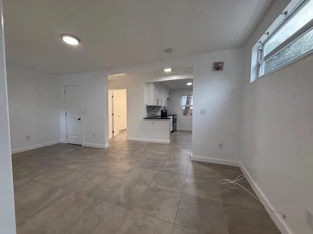 a view of a kitchen with a sink and a refrigerator