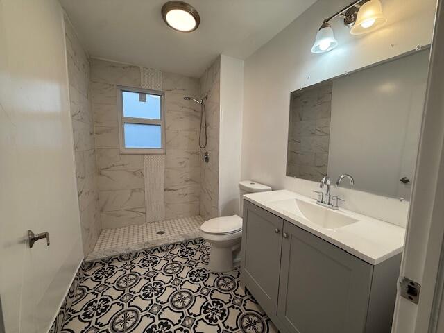 919 2nd Street, Unit 2 West Palm Beach, FL 33401 - Photo 9 of 14 a bathroom with a sink a toilet and shower