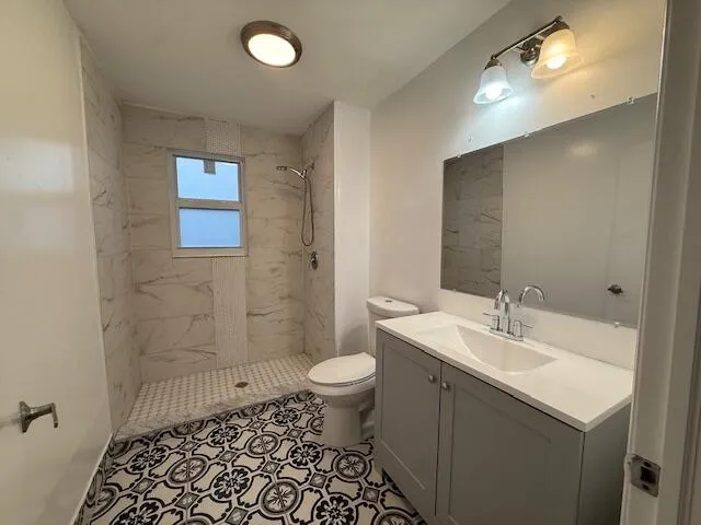 a bathroom with a sink a toilet a shower and a mirror